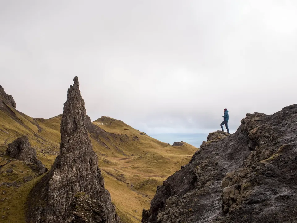 A leader standing alone on a mountain ridge
